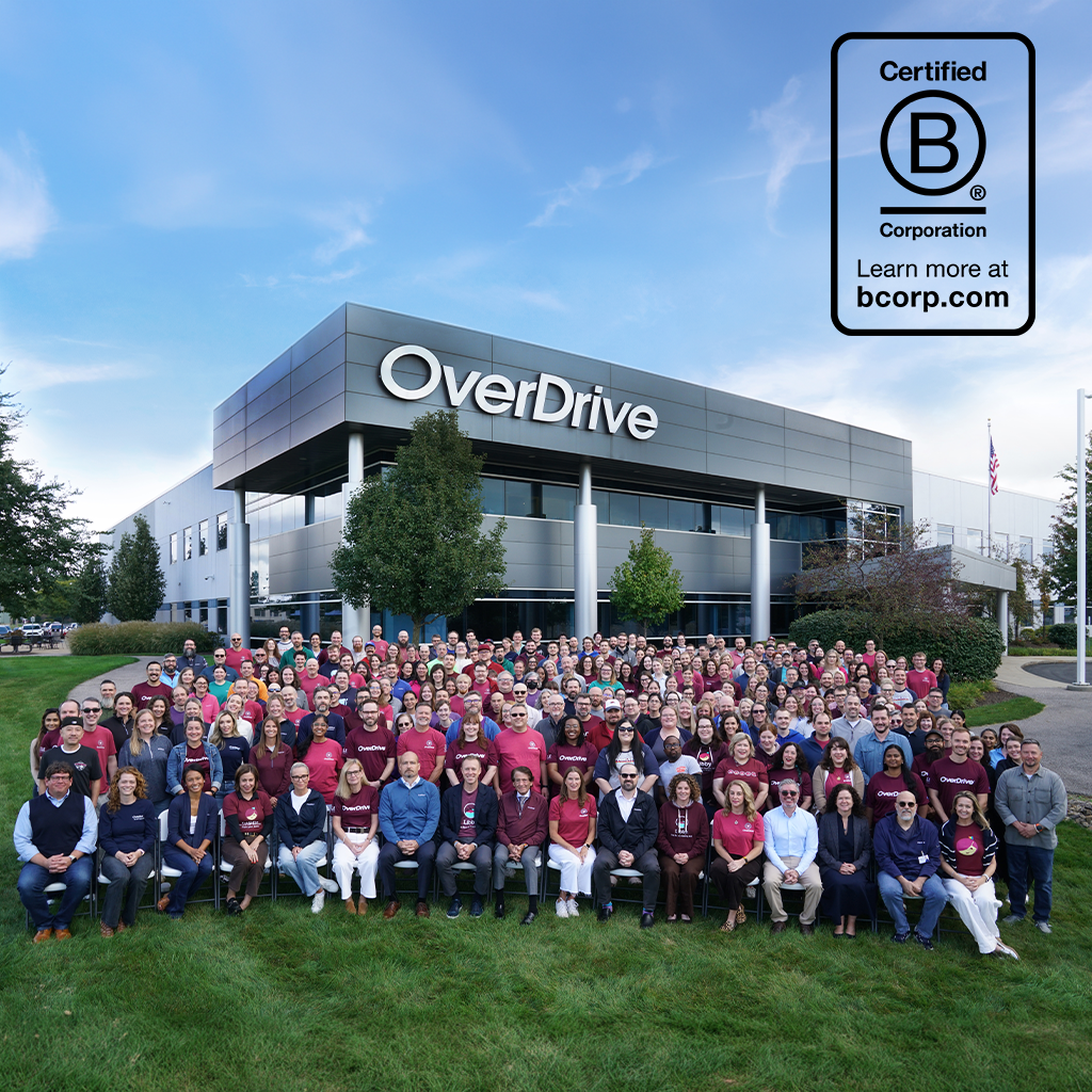 Company photo of employees sitting outside of the OverDrive building